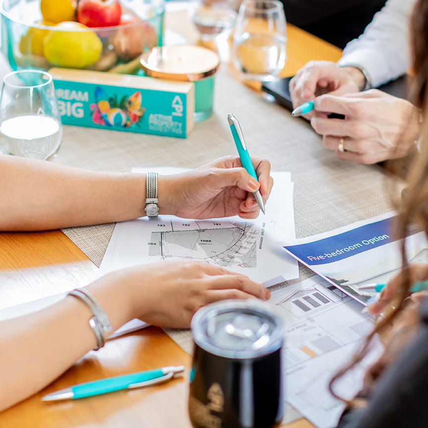 Reviewing property plans and options across a table